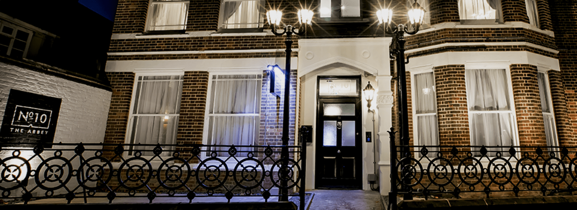 Exterior of No.10 The Abbey boutique accommodation in Wymondham illuminated at dusk