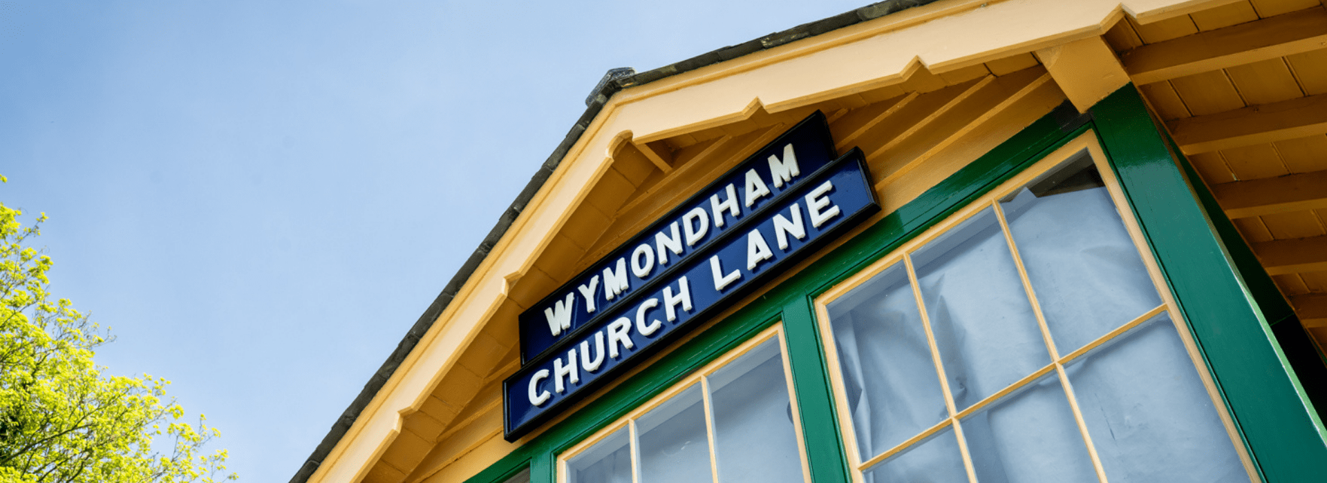 Traditional railway station sign at Wymondham Abbey station on the Mid-Norfolk Railway